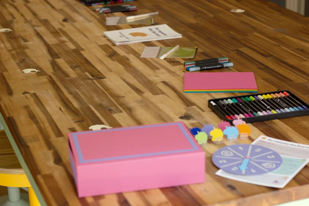 Préparation de la table pour accueillir les enfants lors de l’atelier-jeu d’anniversaire sur le thème des licornes et des princesses.